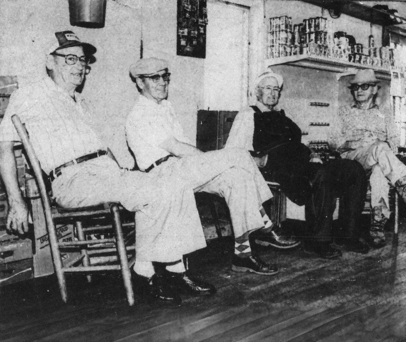 Grady Holtzclaw, Hugh Heard, Rufus Martin and Sack Bolton seated in the back of Holcomb's Store.