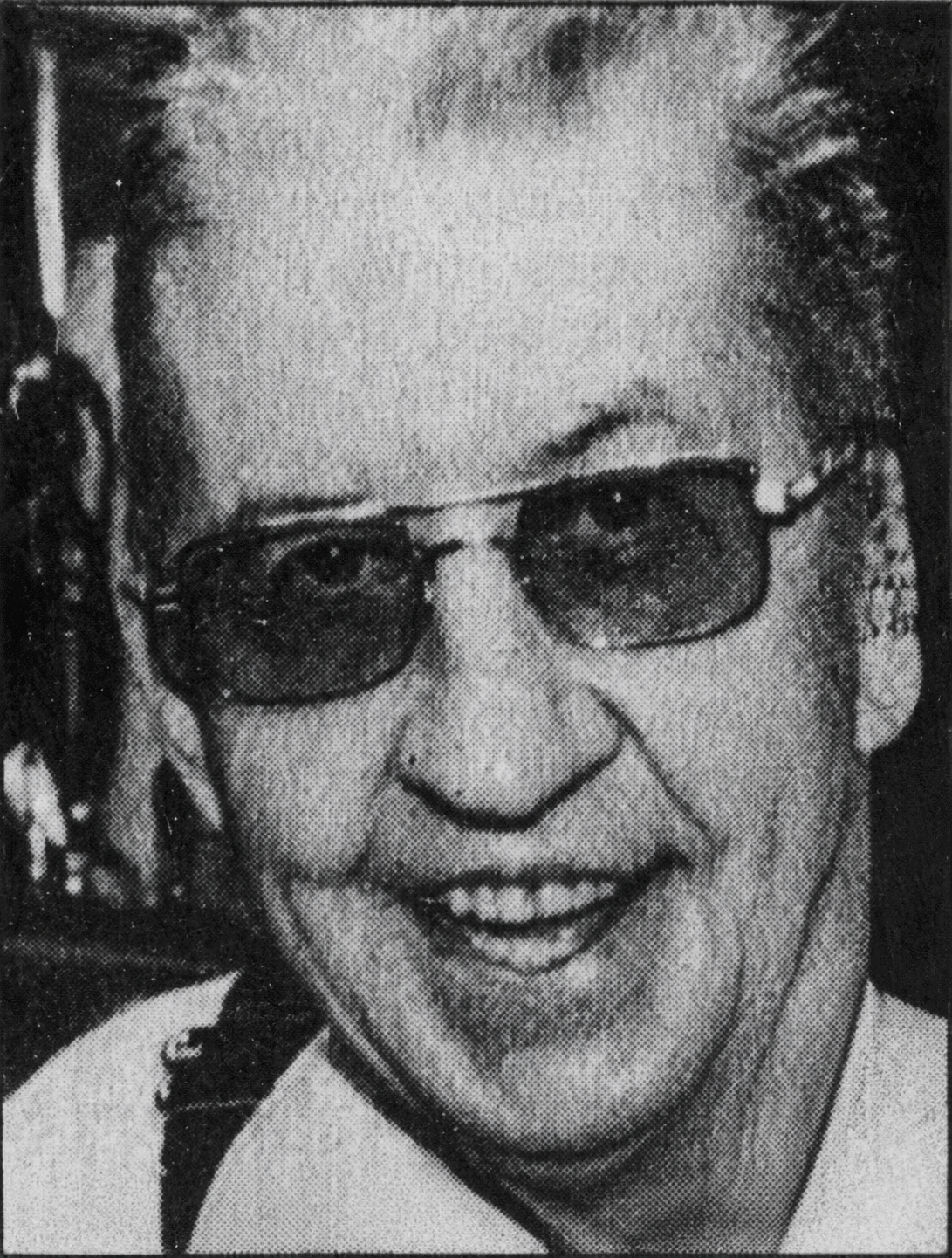 Close-up portrait of Doc Holcomb wearing dark glasses.