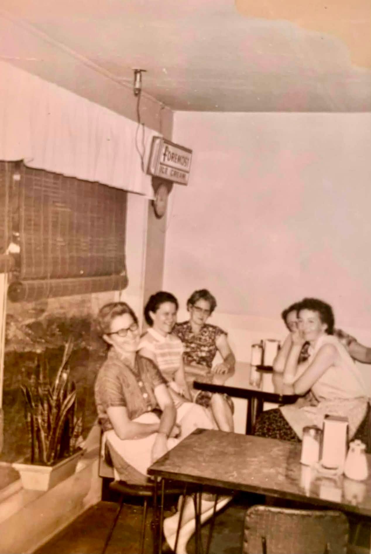 Katie Milford Shoemake seated at far left with other women inside the S&M Cafe around 1960.